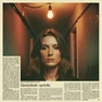 A composited celebrity portrait treated with visible analog film grain and a warm, slightly faded color palette, the face rendered with the soft focus and tonal compression of a 35mm print, set in a moody backstage corridor with a single bare tungsten bulb casting amber light from above, the grain texture visible across the entire image surface, atmosphere nostalgic and intimate. Editorial illustration in the visual language of newsprint broadsheet, evoking 1980s ink and serif columns on cream paper. Palette: #F1EBDB ground, #1B1816 ink, #8B0000 primary highlight, #2A2A26 supporting hue. Soft printed daylight with paper grain. Style: newsprint broadsheet. Mood: solemn.