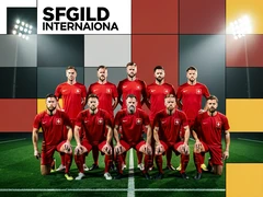 Eleven soccer players in matching red jerseys kneeling and standing in two rows on a green grass pitch, each athlete facing the camera with a determined expression, stadium floodlights casting bright even illumination across all faces, a wide-angle lens capturing the full team with sharp detail from edge to edge, competitive and unified team spirit. Swiss International Typographic Style poster aesthetic, modular grid composition with flat geometric color blocks and decoration-free surfaces. Palette built on #FFFFFF, #0F0F0F, #E63946, and #FFD700, with no gradients. Even diffused studio lighting, crisp edges, minimal shadow falloff. Style: Swiss grid poster. Mood: precise and authoritative.