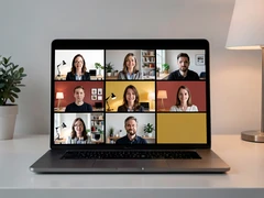 A grid of six video call participants displayed on a laptop screen, each person visible in their own tile against different home-office backgrounds, faces clearly lit by monitor glow and desk lamps, the laptop sitting on a clean white desk, soft ambient room lighting supplementing the screen glow, a modern remote-work atmosphere with a clean minimal aesthetic. Swiss International Typographic Style poster aesthetic, modular grid composition with flat geometric color blocks and decoration-free surfaces. Palette built on #FFFFFF, #0F0F0F, #E63946, and #FFD700, with no gradients. Even diffused studio lighting, crisp edges, minimal shadow falloff. Style: Swiss grid poster. Mood: precise and authoritative.